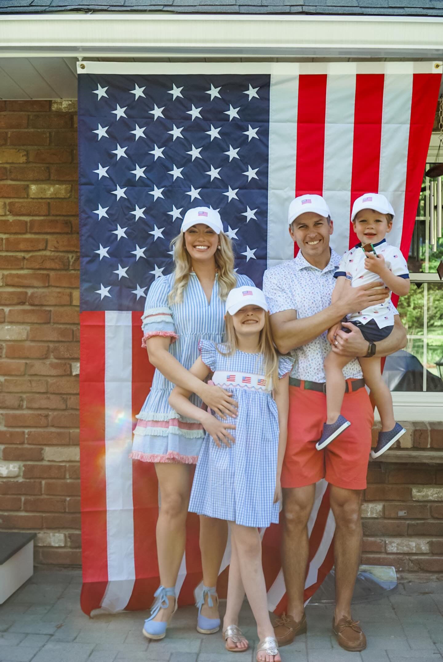 Family wearing matching baseball hat with American flag embroidery