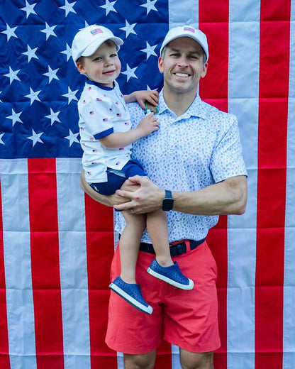 Dad and son wearing matching baseball hat with American flag embroidery