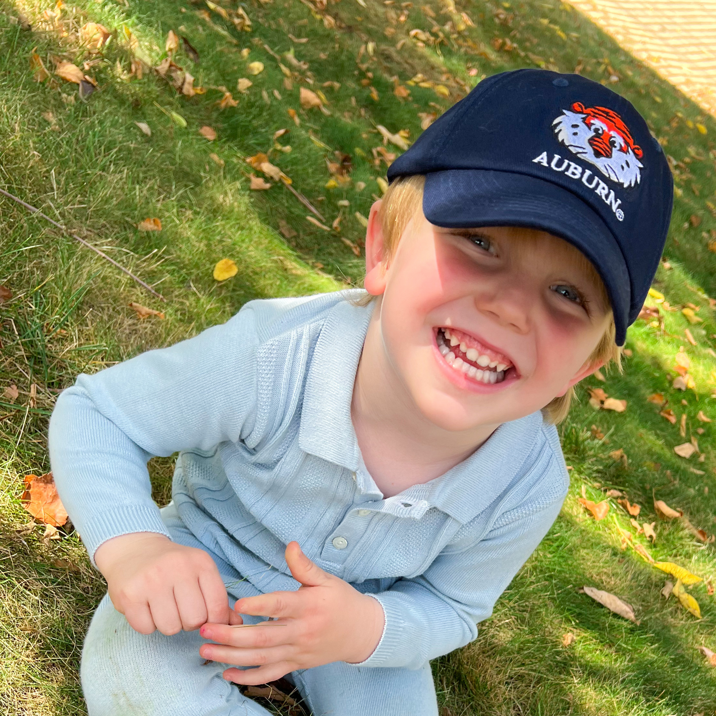 Little boy wearing Auburn Tigers baseball hat 