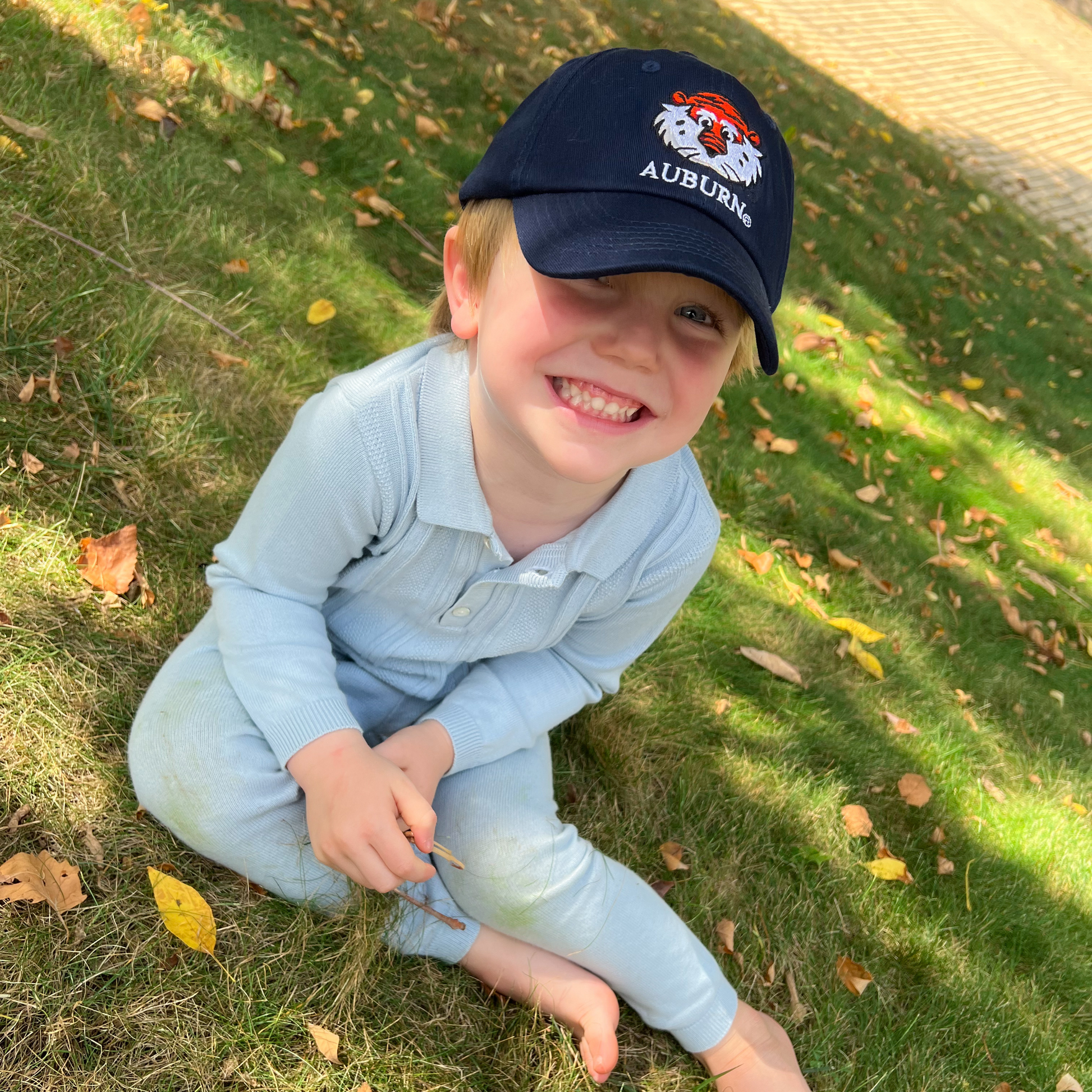 Little boy wearing Auburn Tigers baseball hat 