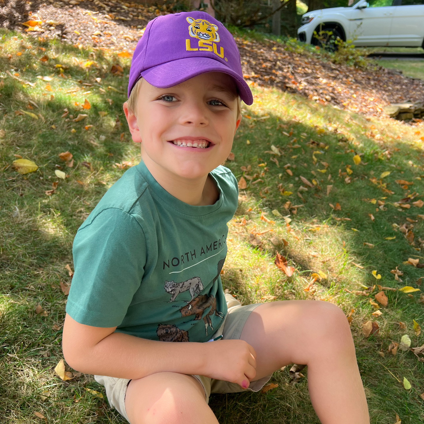 Boy wearing a purple baseball hat with LSU Tigers embroidery