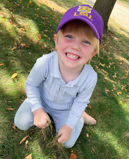 Boy wearing a purple baseball hat with LSU Tigers embroidery