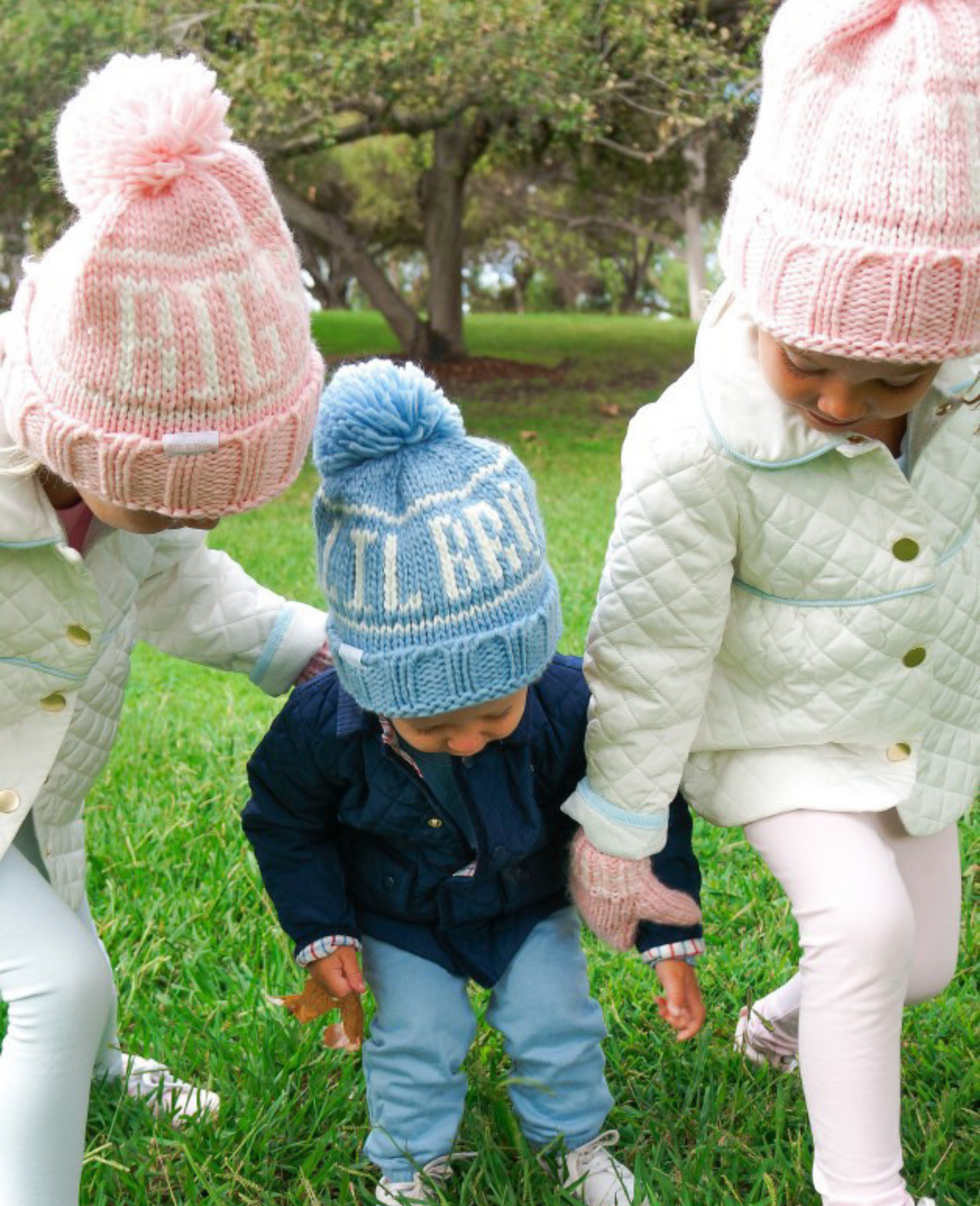 Little boy and girls wearing sibling bobble hats