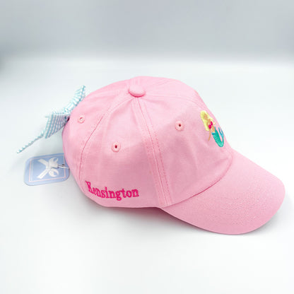 Pink baseball hat with mermaid embroidery on the front, a bow on the back and a name embroidered on the side