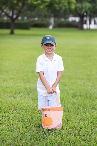 Boy holding an orange tote with pumpkin applique