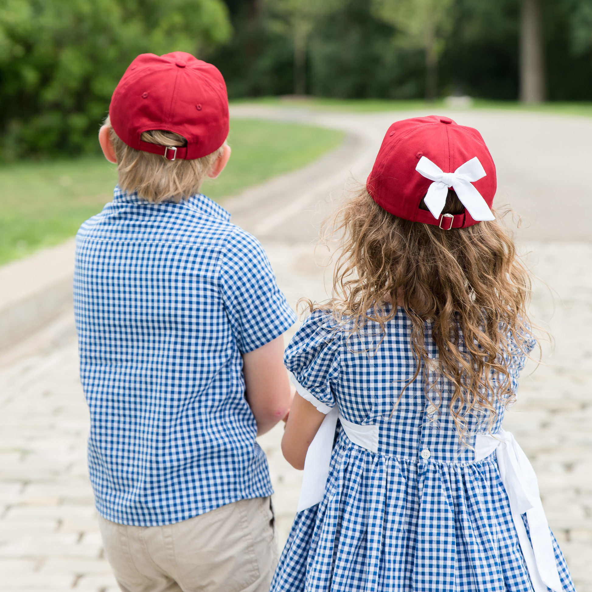 Little boy and girl wearing coordinating red baseball hats