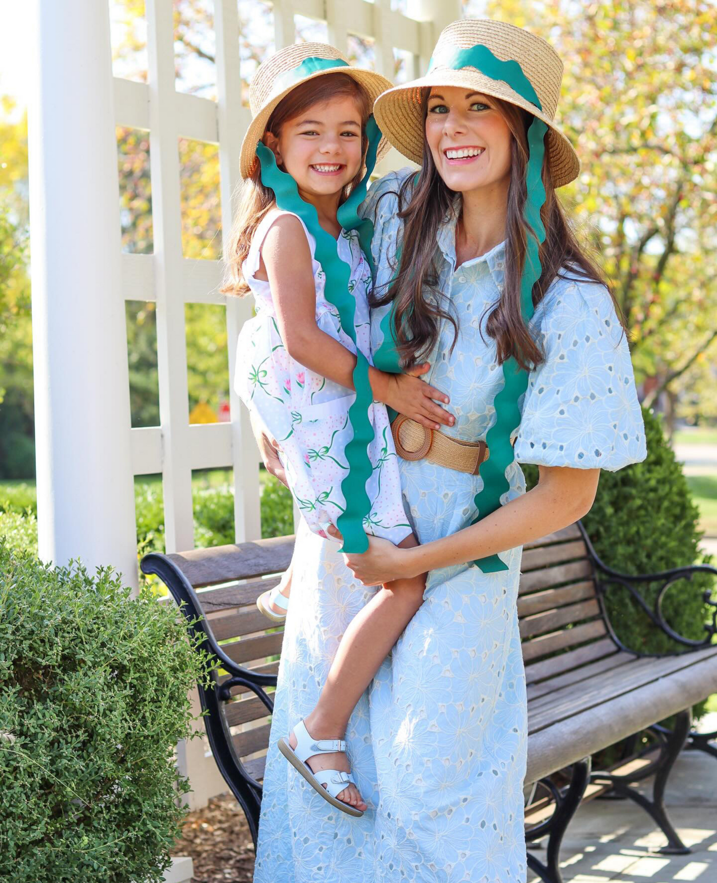 Mom and daughter wearing matching straw hats with green ric rac ribbon