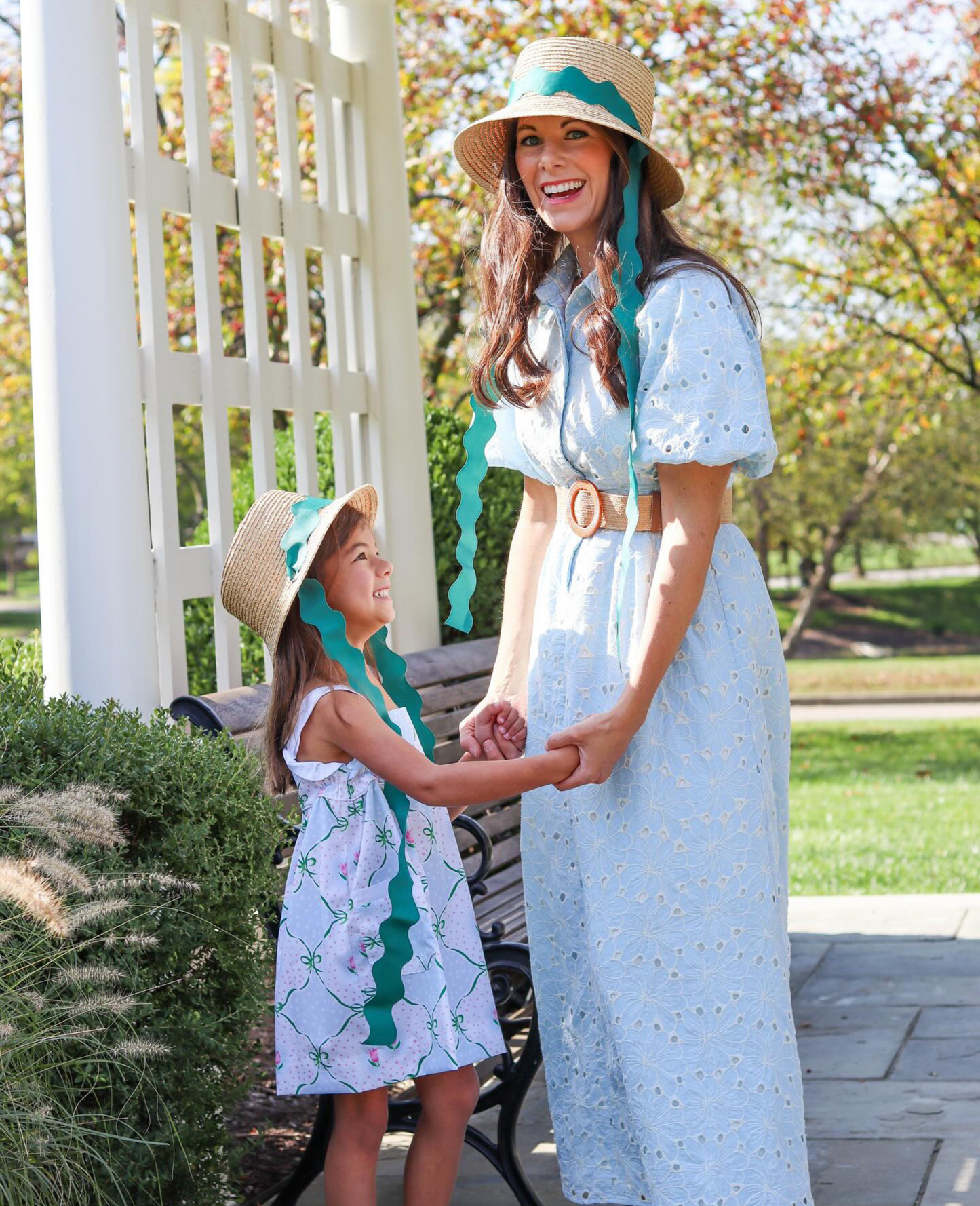 Mom and daughter wearing matching straw hats with green ric rac ribbon