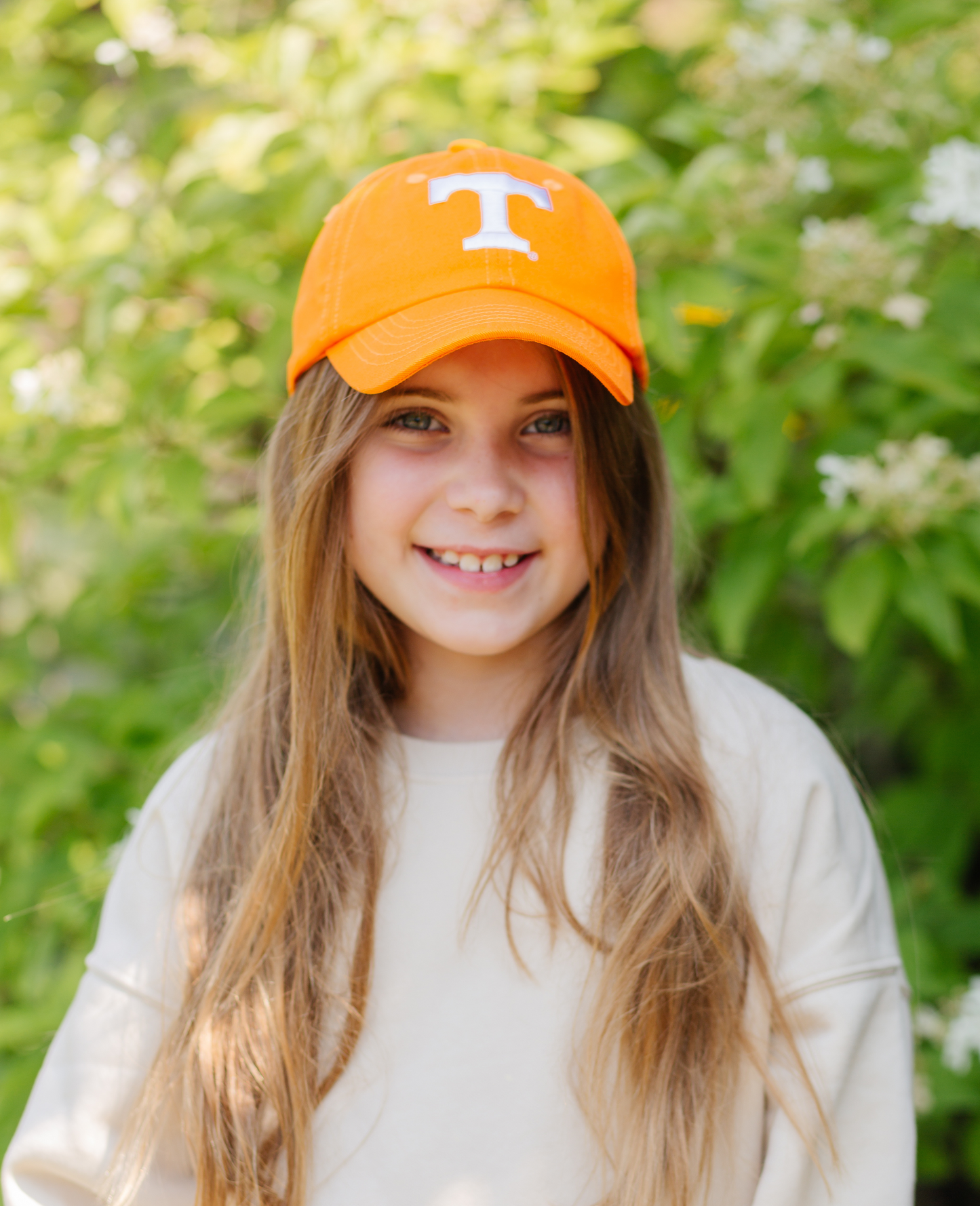 Girl wearing an orange Tennessee Vols baseball hat